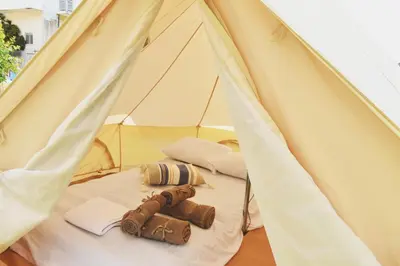 a white tent with a pair of shoes in it at Camping Tent Downtown & Garden Hanging Bed in Porto Rafti