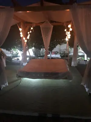 a bed in a tent with lights and curtains at Camping Tent Downtown & Garden Hanging Bed in Porto Rafti