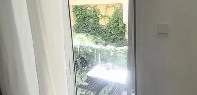 an open door to a patio with a table and chairs at Luxury apartment 3 rooms near metro in Athens