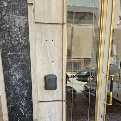 a door with a mailbox on the side of a building at Luxury apartment 3 rooms near metro in Athens