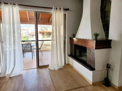 a living room with a fireplace and sliding glass doors at Retro Panoramic Rooftop VIPGreece in Athens