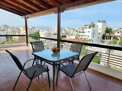 a table and chairs on a balcony with a view at Retro Panoramic Rooftop VIPGreece in Athens