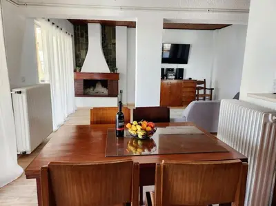 a dining room with a table with a bowl of fruit on it at Retro Panoramic Rooftop VIPGreece in Athens