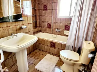 a bathroom with a sink and a toilet and a tub at Retro Panoramic Rooftop VIPGreece in Athens