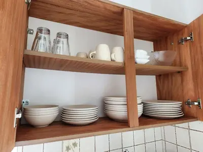 a kitchen cabinet with plates and bowls and dishes at Retro Panoramic Rooftop VIPGreece in Athens