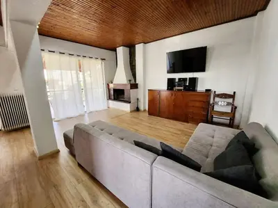 a living room with a couch and a flat screen tv at Retro Panoramic Rooftop VIPGreece in Athens