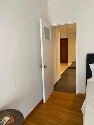 a living room with a couch and a hallway at Marina Access in Athens