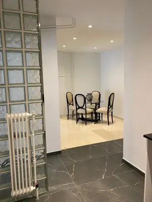 a dining room with chairs and a table in a room at Marina Access in Athens