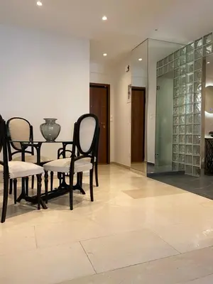 a dining room with chairs and a table and a mirror at Marina Access in Athens
