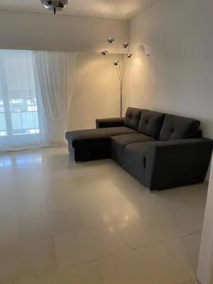 a living room with a couch and a large window at Marina Access in Athens