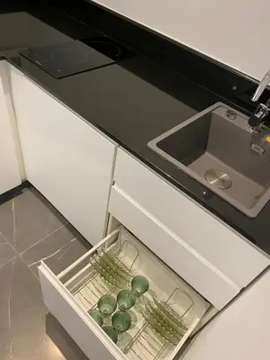 an open kitchen drawer with green vegetables in it at Marina Access in Athens