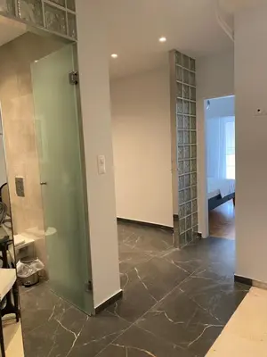 a room with a glass door and a bedroom at Marina Access in Athens
