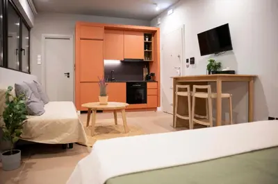 a small living room with a couch and a table at G&H Acropolis Stays! Iconic Views, Stylish Comfort in Athens