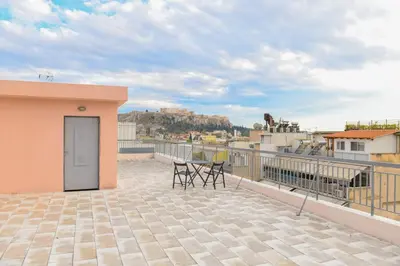 a balcony with chairs and a door on a building at G&H Acropolis Stays! Iconic Views, Stylish Comfort in Athens