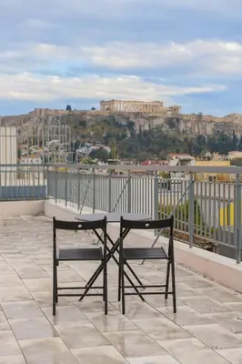 a bench sitting on top of a roof at G&H Acropolis Stays! Iconic Views, Stylish Comfort in Athens