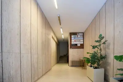a hallway with wood paneled walls and a long corridor at G&H Acropolis Stays! Iconic Views, Stylish Comfort in Athens