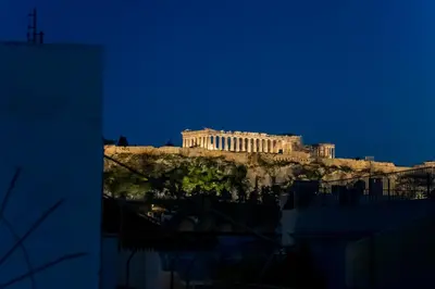 a view of the acropolis at night at G&H Acropolis Stays! Iconic Views, Stylish Comfort in Athens