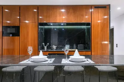 a kitchen with a table with wine glasses and a counter at Modern Two-Bedroom Apartment In Kolonaki, Peridot - Homes in Athens