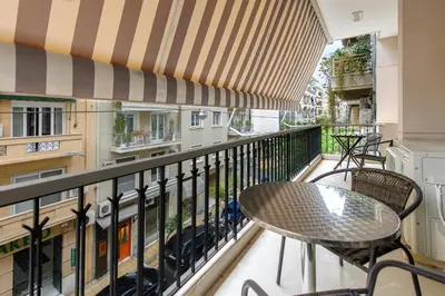 a balcony with a table and chairs on it at Modern Two-Bedroom Apartment In Kolonaki, Peridot - Homes in Athens
