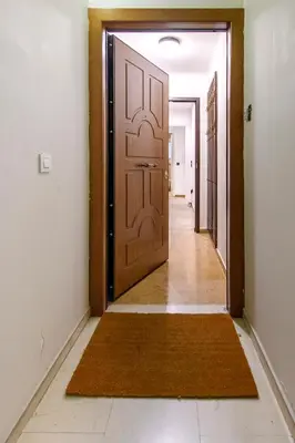 a hallway with a door and a rug at Modern Two-Bedroom Apartment In Kolonaki, Peridot - Homes in Athens