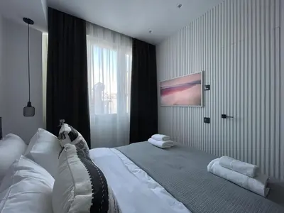 a bedroom with a bed with white sheets and a window at Monastiraki 512 SuperHost Hub in Athens