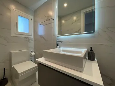 a white bathroom with a sink and a toilet at Monastiraki 512 SuperHost Hub in Athens