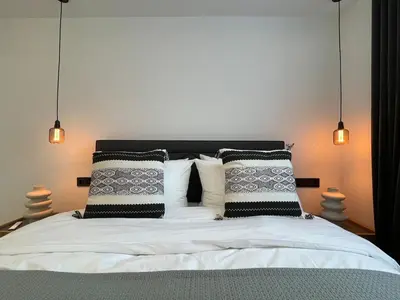 a bedroom with a bed with black and white pillows at Monastiraki 512 SuperHost Hub in Athens