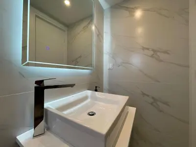 a white bathroom with a sink and a mirror at Monastiraki 512 SuperHost Hub in Athens