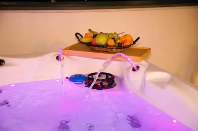 a bowl of fruit sitting in a bath tub at Alex Suite Θερμαινόμενο Τζακούζι & Θέα Ακρόπολη in Athens
