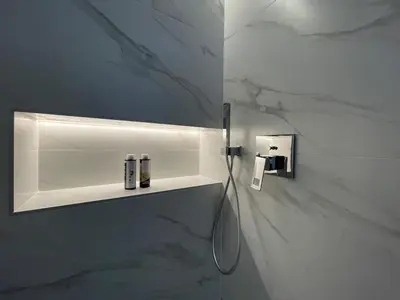 a bathroom with a white marble wall with a shelf at Monastiraki 513 SuperHost Hub in Athens