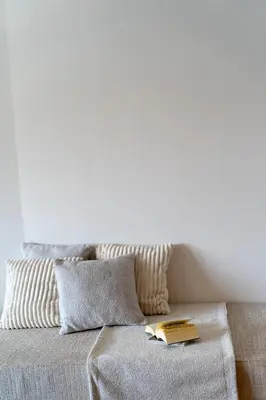 a bed with two pillows and a book on it at Athens Design Suites in Athens