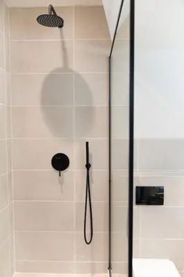 a shower with a glass door in a bathroom at Athens Design Suites in Athens