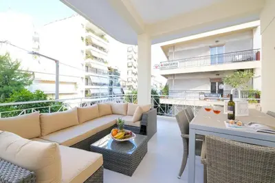a living room with a couch and a table at Hidden gem on the Piraeus Coast in Piraeus