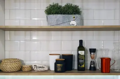 a shelf with a bottle of wine and other items on it at Hidden gem on the Piraeus Coast in Piraeus