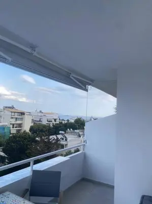 a balcony with a view of a city at Serafina suite byArtistUnknown in Vari