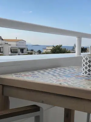 a balcony with a table with a view at Serafina suite byArtistUnknown in Vari