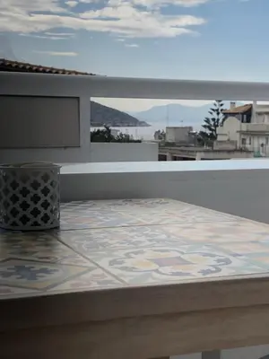 a balcony with a table with a tile floor at Serafina suite byArtistUnknown in Vari