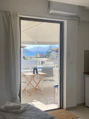 a room with a sliding glass door leading to a patio at Serafina suite byArtistUnknown in Vari
