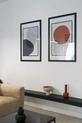 a living room with two pictures and a couch and a table at Academy Elegant Apartment #101 in Athens