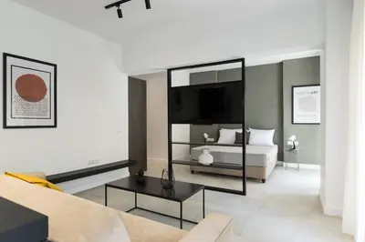 a living room with a bed and a couch at Academy Elegant Apartment #101 in Athens