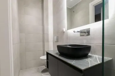 a bathroom with a black sink on a counter at Academy Elegant Apartment #101 in Athens