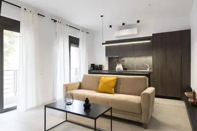 a living room with a couch and a table at Academy Elegant Apartment #101 in Athens