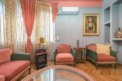 a living room with chairs and a glass table at Rest sleep repeat by museum in a modern Victorian way in Athens