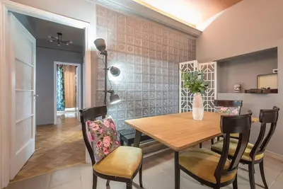 a dining room with a wooden table and chairs at Rest sleep repeat by museum in a modern Victorian way in Athens