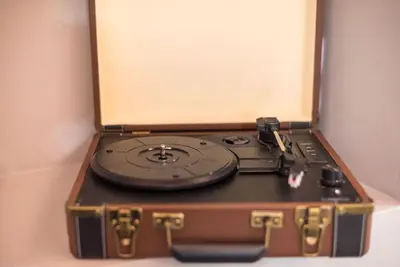 a record player sitting on top of a suitcase at Rest sleep repeat by museum in a modern Victorian way in Athens