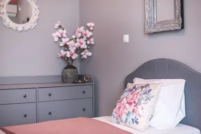 a bedroom with a bed with a pillow and a dresser at Rest sleep repeat by museum in a modern Victorian way in Athens