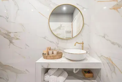 a bathroom with a sink and a mirror at Rest sleep repeat by museum in a modern Victorian way in Athens
