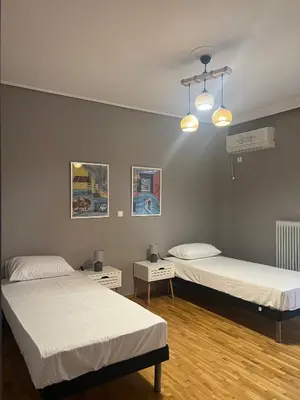 a room with two beds and a ceiling at anastasis house in Athens