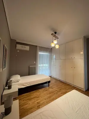 a large bedroom with a bed and a window at anastasis house in Athens