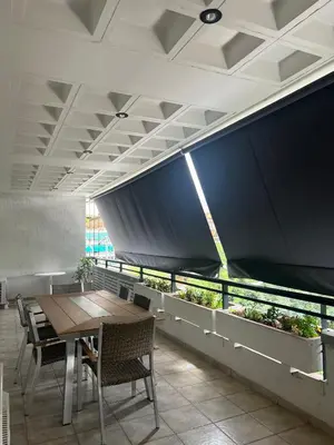a dining room with a table and chairs and plants at anastasis house in Athens